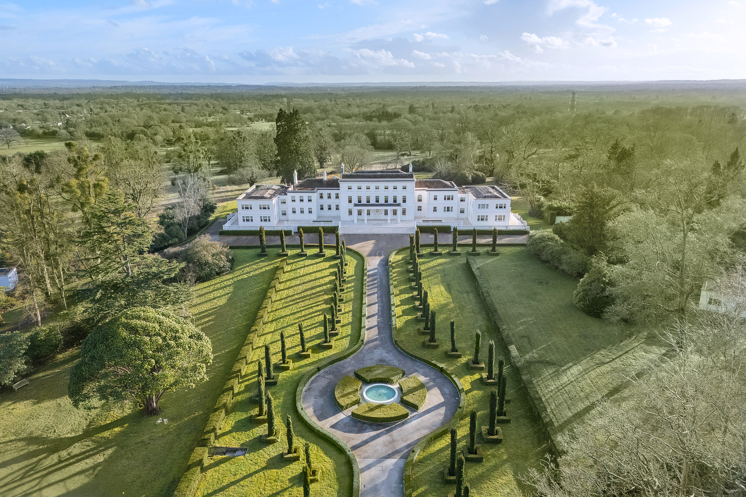 Grand Surrey mansion approached through formal gardens and mature parkland